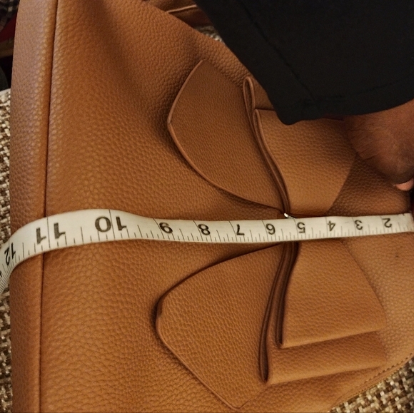 Crossi women's tan bow mini back pack w/ adjustable straps and interior pockets - Picture 12 of 12